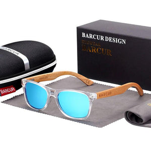 Children's polarized sunglasses with bamboo arms and green lenses in front of hard case, bag and cleaning cloth