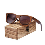 Brown skateboard wood sunglasses on wooden case