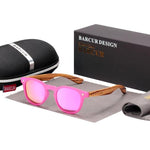 Polarised Kids Round Zebra Wood Sunglasses with pink frames and lenses, hard case, soft bag and cleaning cloth